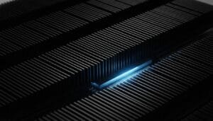 Close-up of parallel black metal fins with a single blue-lit chip or component in the center, suggesting advanced technology or electronics.