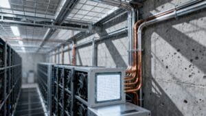 Rows of computer servers and cooling fans, supporting cutting-edge Neuro-Symbolic AI, are arranged along a corridor in an industrial room with exposed concrete walls and metal pipes.